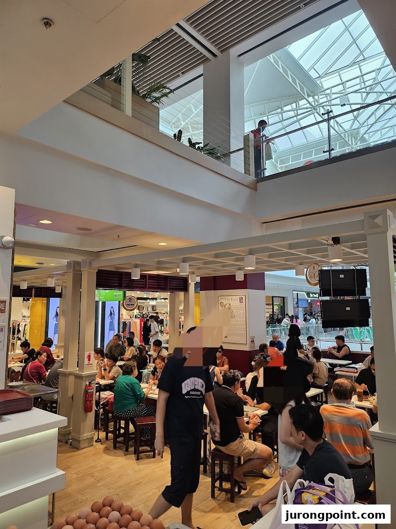 A bustling Ya Kun Family Cafe interior filled with customers enjoying their meals in a mall setting.