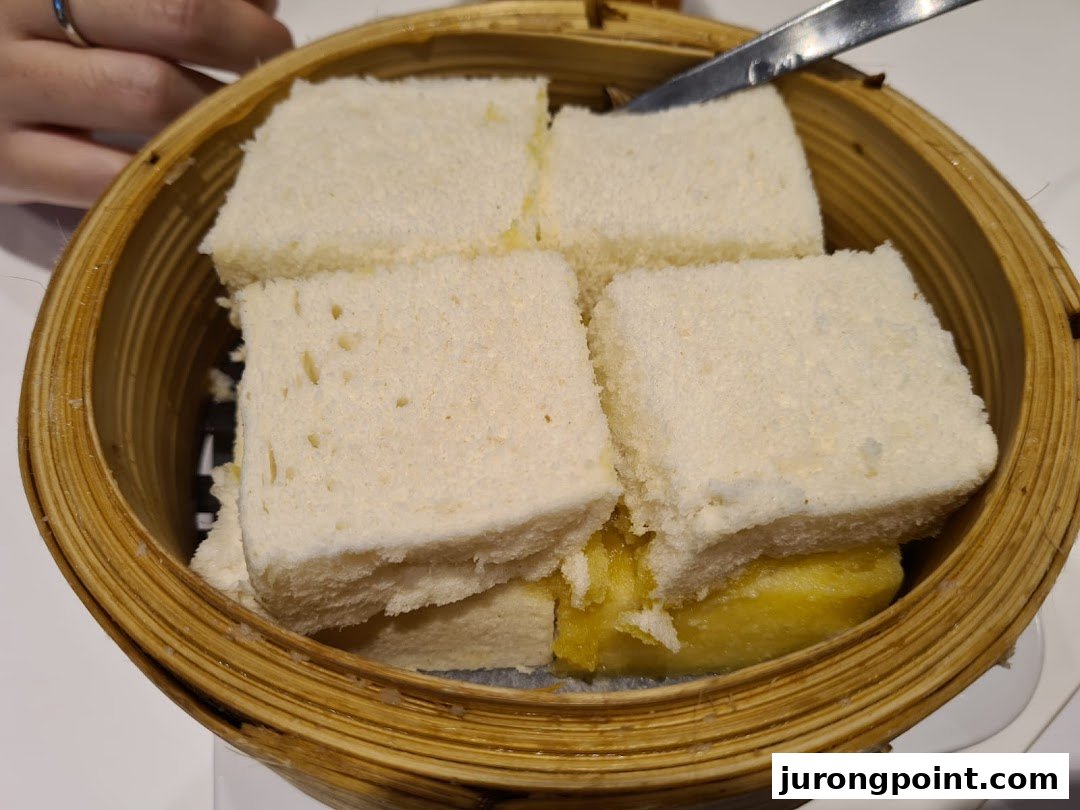 Steamed bread with kaya and butter served in a traditional bamboo steamer at Ya Kun Family Cafe.