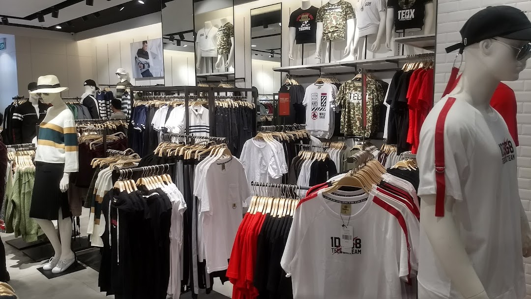 Interior view of YISHION clothing store, showcasing various apparel on mannequins and racks.