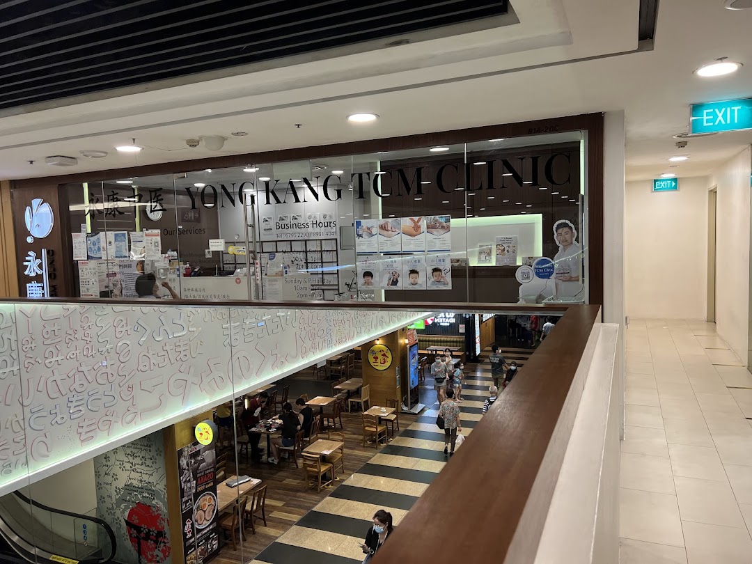 The shopfront of Yong Kang TCM Clinic, seen from an upper level in a shopping mall.