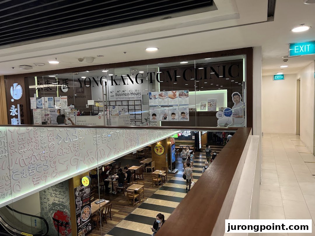 The shopfront of Yong Kang TCM Clinic, seen from an upper level in a shopping mall.
