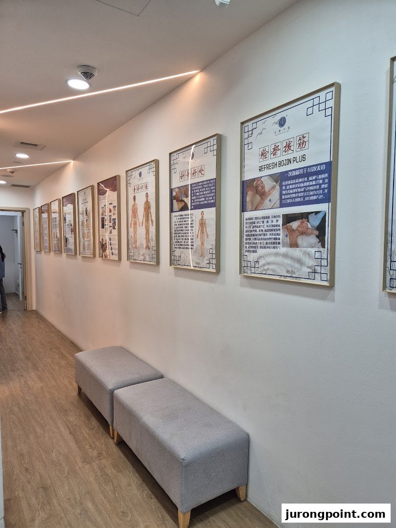 An interior hallway of Yong Kang TCM Clinic featuring informational posters and waiting benches.