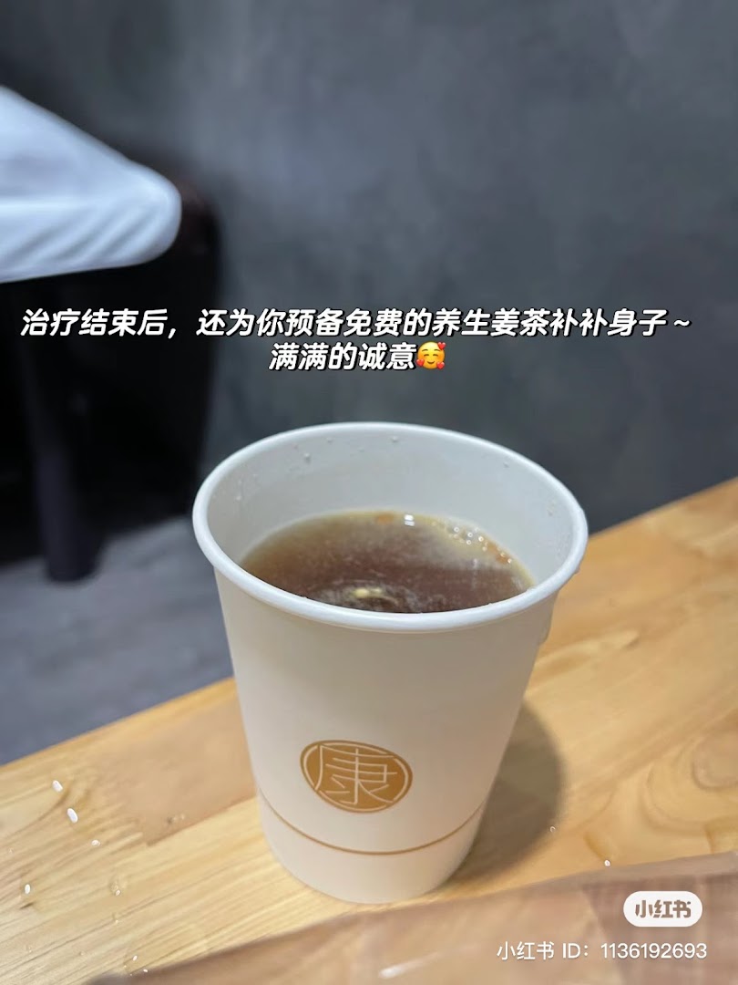 A paper cup of health-preserving ginger tea offered after treatment at Yong Kang TCM Clinic.