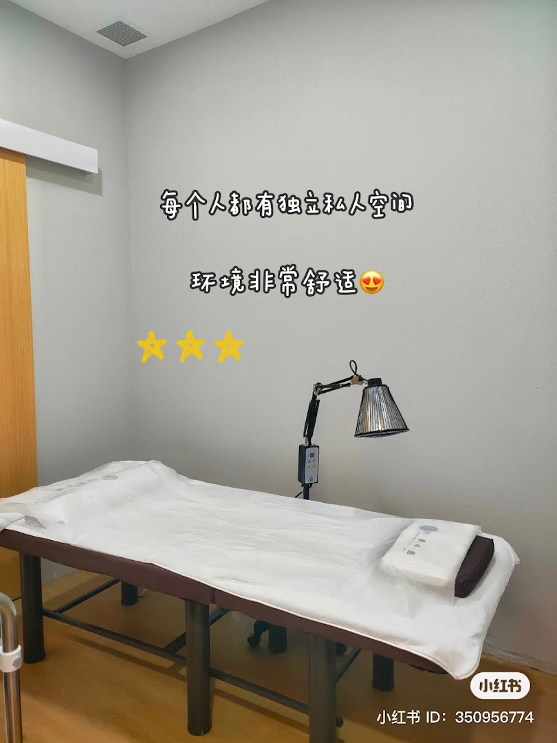 A private treatment room with a bed and heat lamp, emphasizing comfort and personal space.