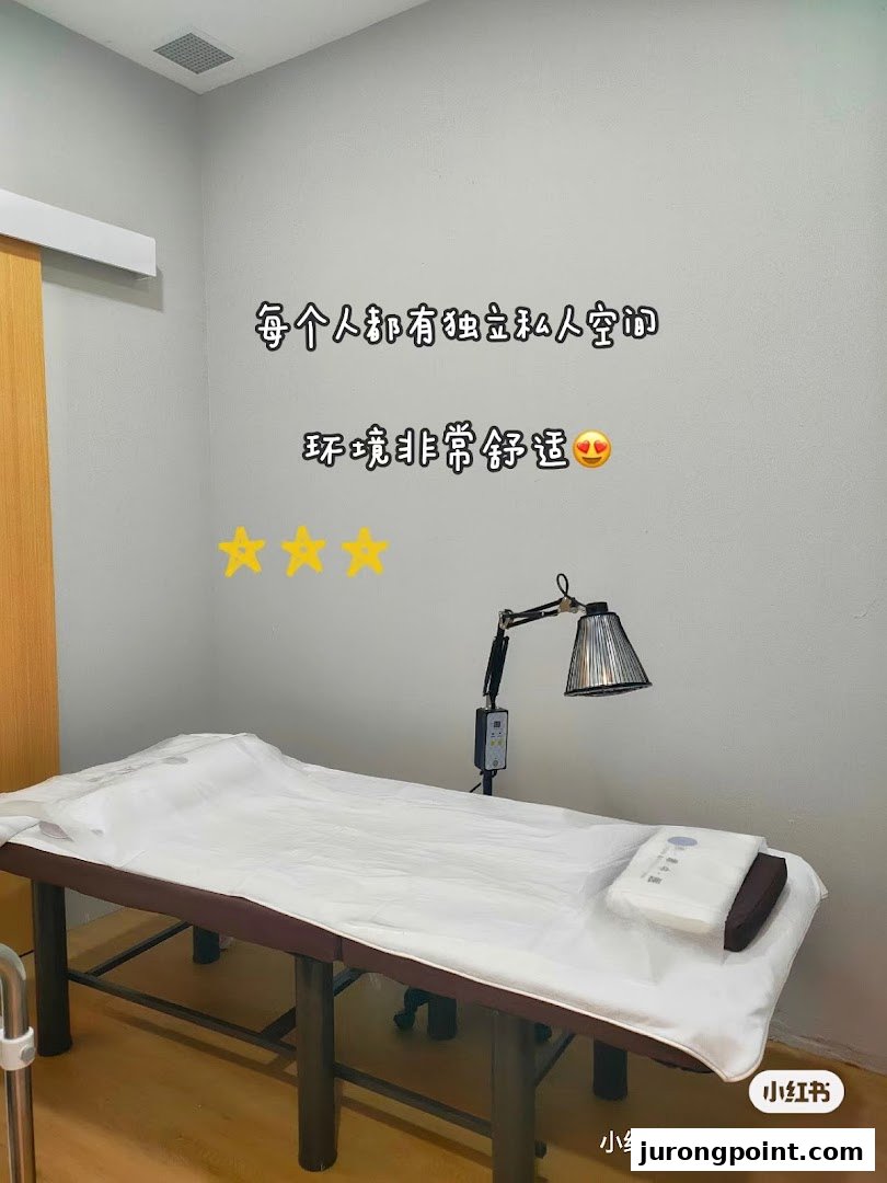 A private treatment room with a bed and heat lamp, emphasizing comfort and personal space.