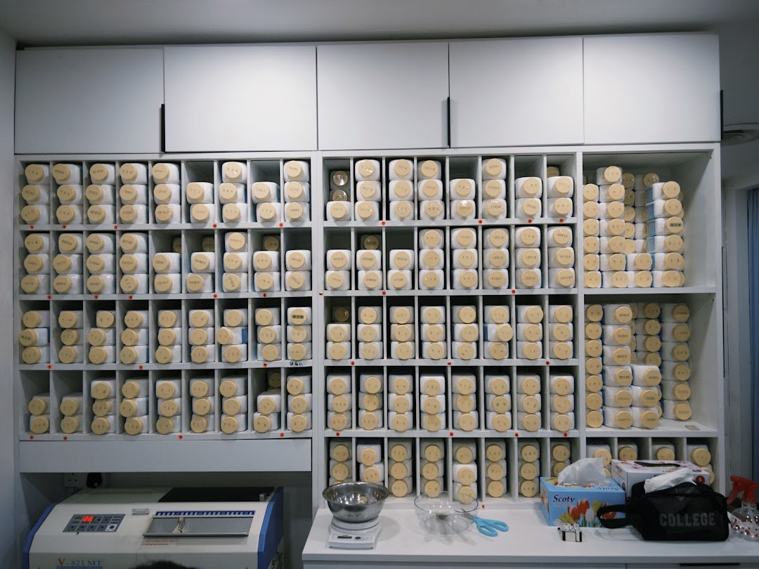 Interior view of Yong Kang TCM Clinic, featuring shelves stocked with numerous traditional herbal medicine containers.