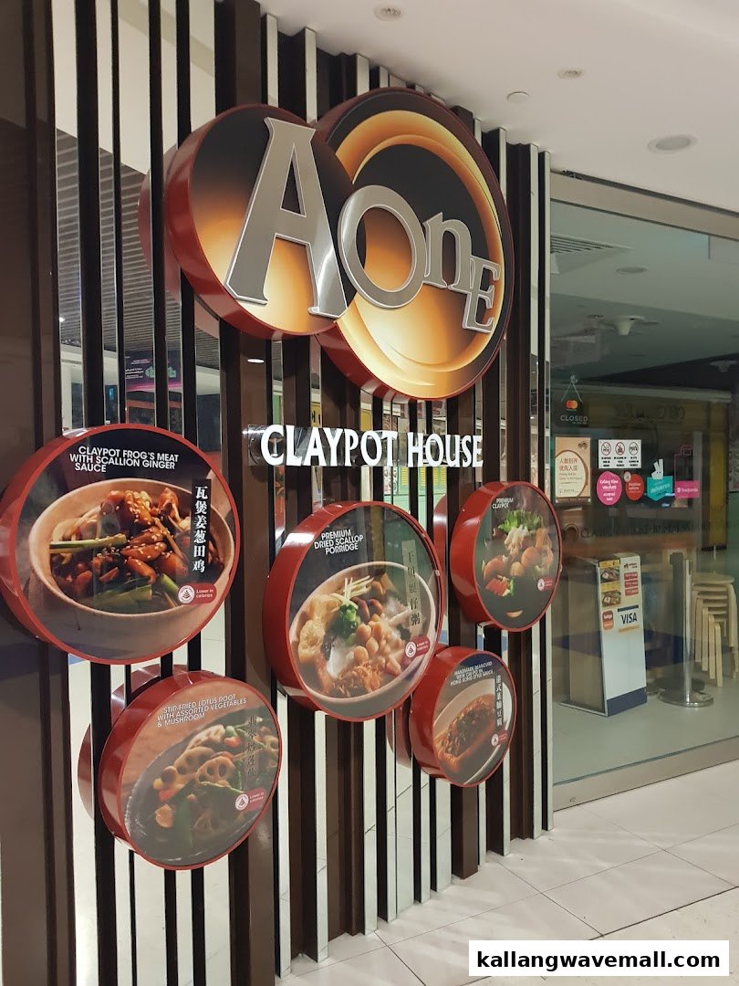The shop front of A-One Signature Claypot House, featuring its logo and illuminated circular displays of signature dishes.