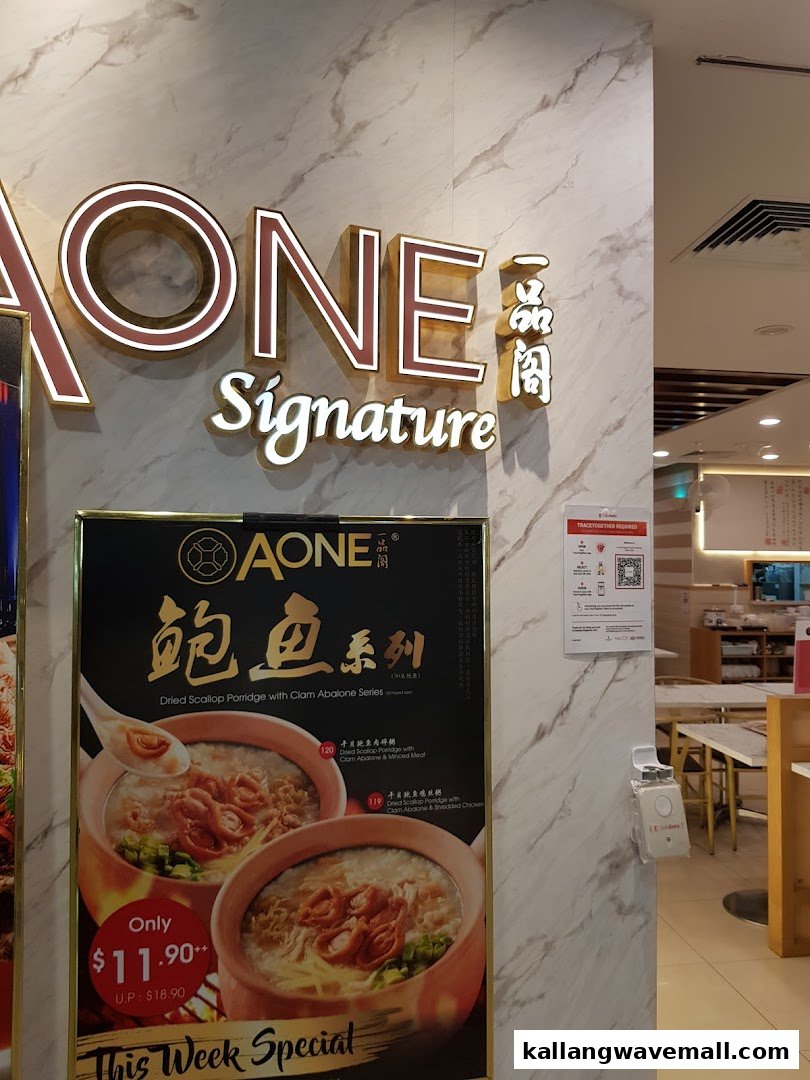 A-One Signature shop interior featuring a promotional poster for their Dried Scallop Porridge with Clam Abalone Series.