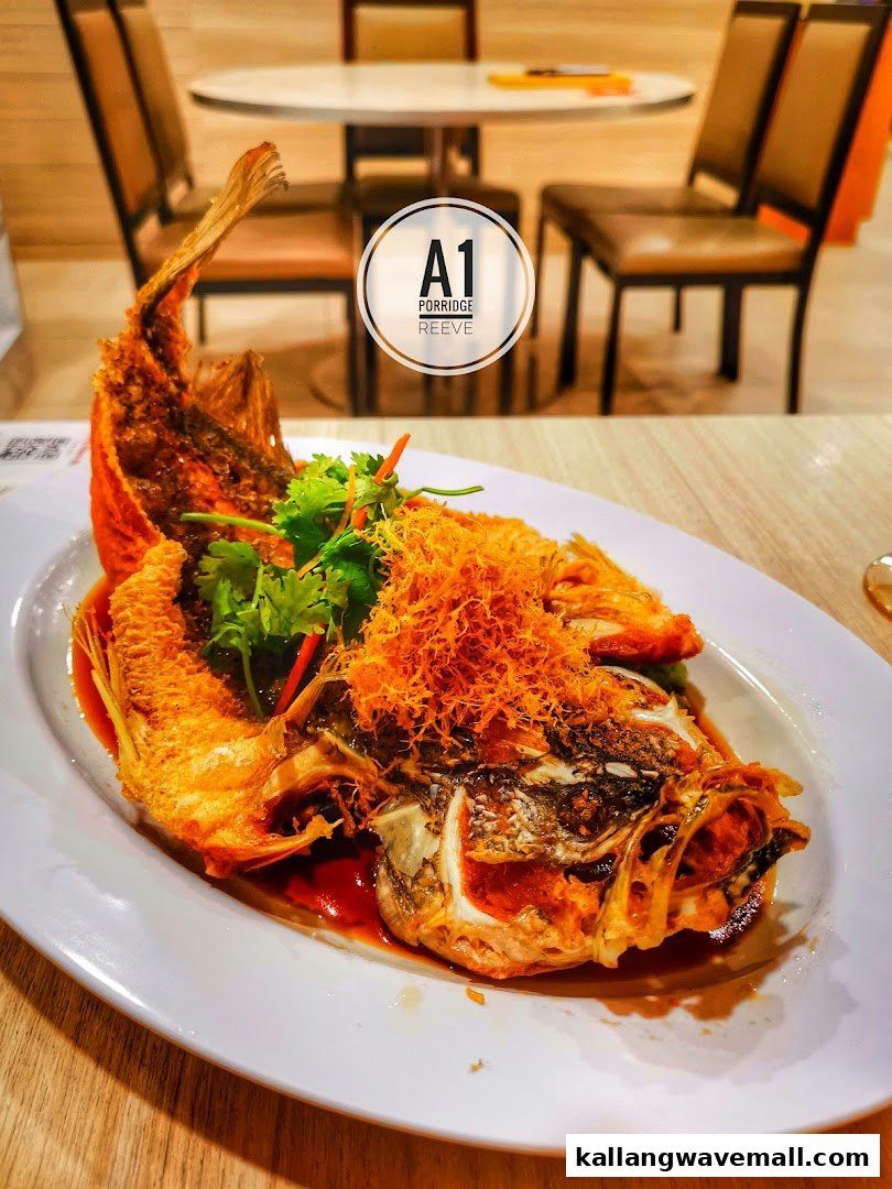 A beautifully presented deep-fried fish dish with crispy topping and fresh herbs at A1 Porridge.