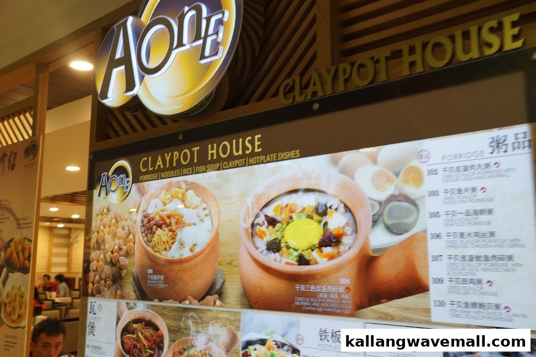 A large display board showcasing various porridge and claypot dishes with detailed menu item listings.