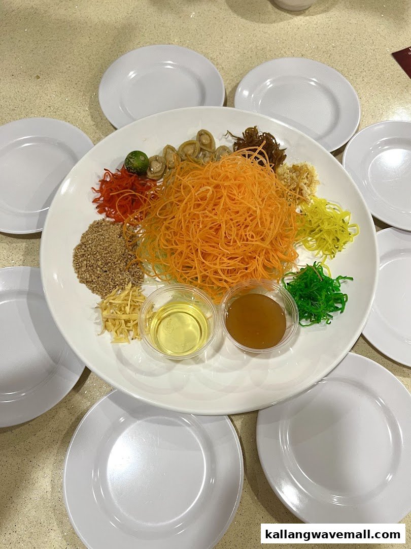 A vibrant Yu Sheng platter with various ingredients and individual plates, ready for a festive toss.