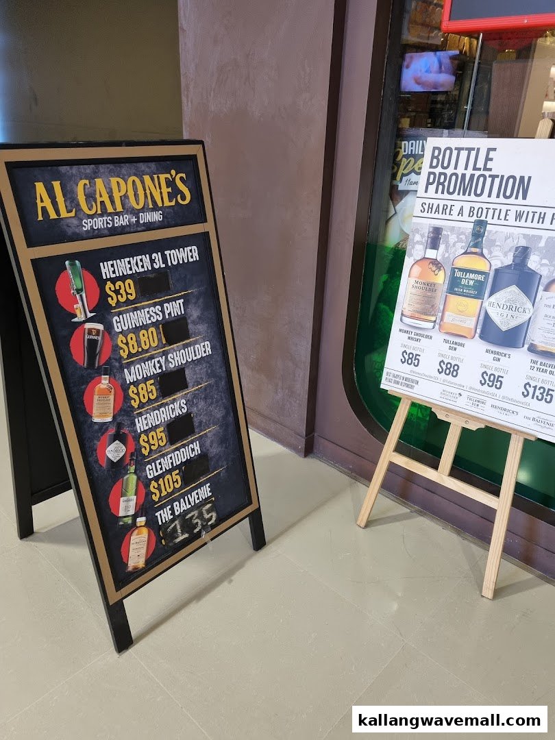 Two promotional signs for Al Capone's Sports Bar + Dining, featuring drink prices and bottle promotions.