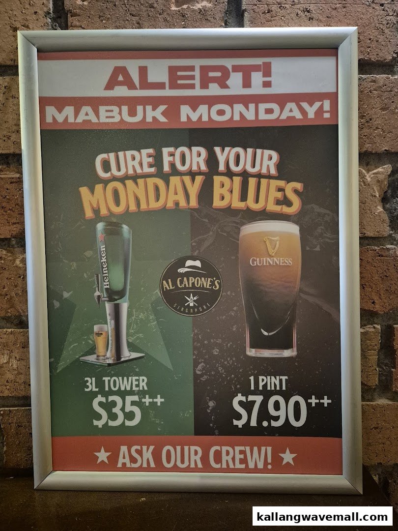 A framed promotional poster for 'Mabuk Monday' drink specials at Al Capone's, featuring beer towers and pints.