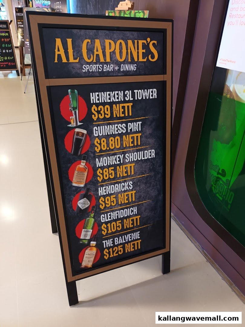 A blackboard-style sign for Al Capone's Sports Bar + Dining, showcasing drink specials and prices.