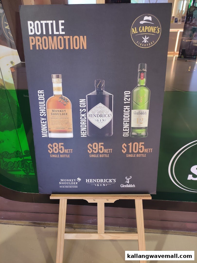A promotional stand displaying bottle promotions for Monkey Shoulder, Hendrick's Gin, and Glenfiddich 12YO.