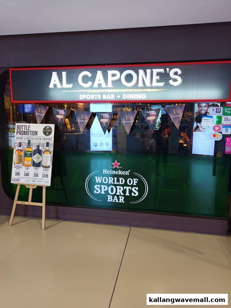 Exterior view of Al Capone's Sports Bar + Dining, featuring its entrance and a bottle promotion stand.