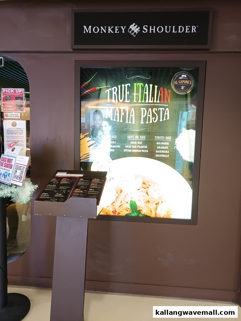 An illuminated display at Al Capones showcasing 'True Italian Mafia Pasta' with various bases and ingredients.