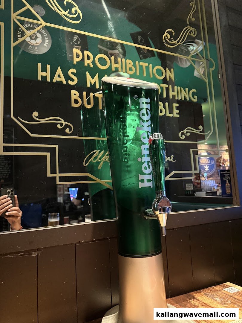A Heineken beer tower on a wooden table, reflecting a mirror with a prohibition-era quote.