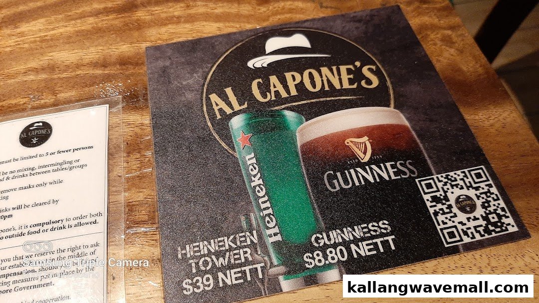 A table tent menu from Al Capone's featuring Heineken Tower and Guinness beer prices.