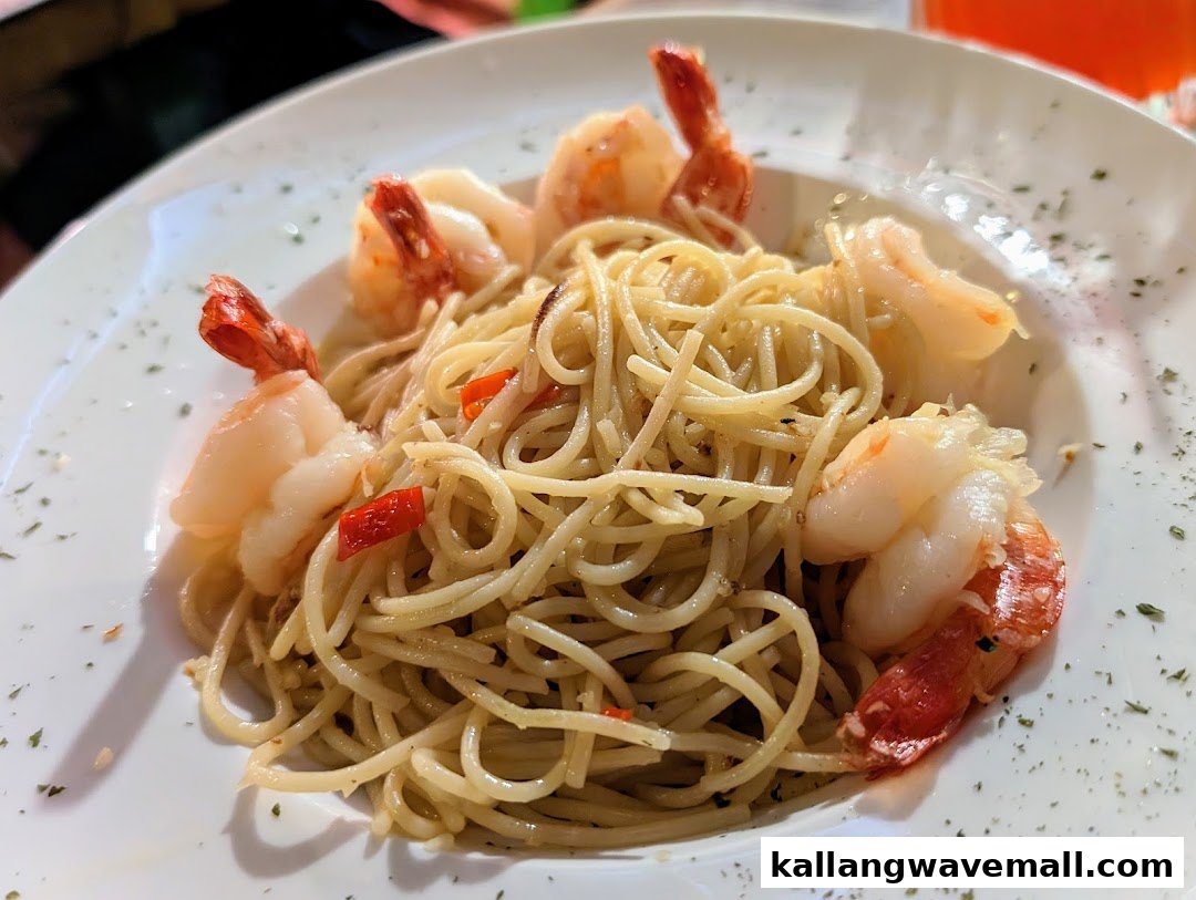 A close-up of a delicious plate of spaghetti with succulent shrimp and red chili flakes.