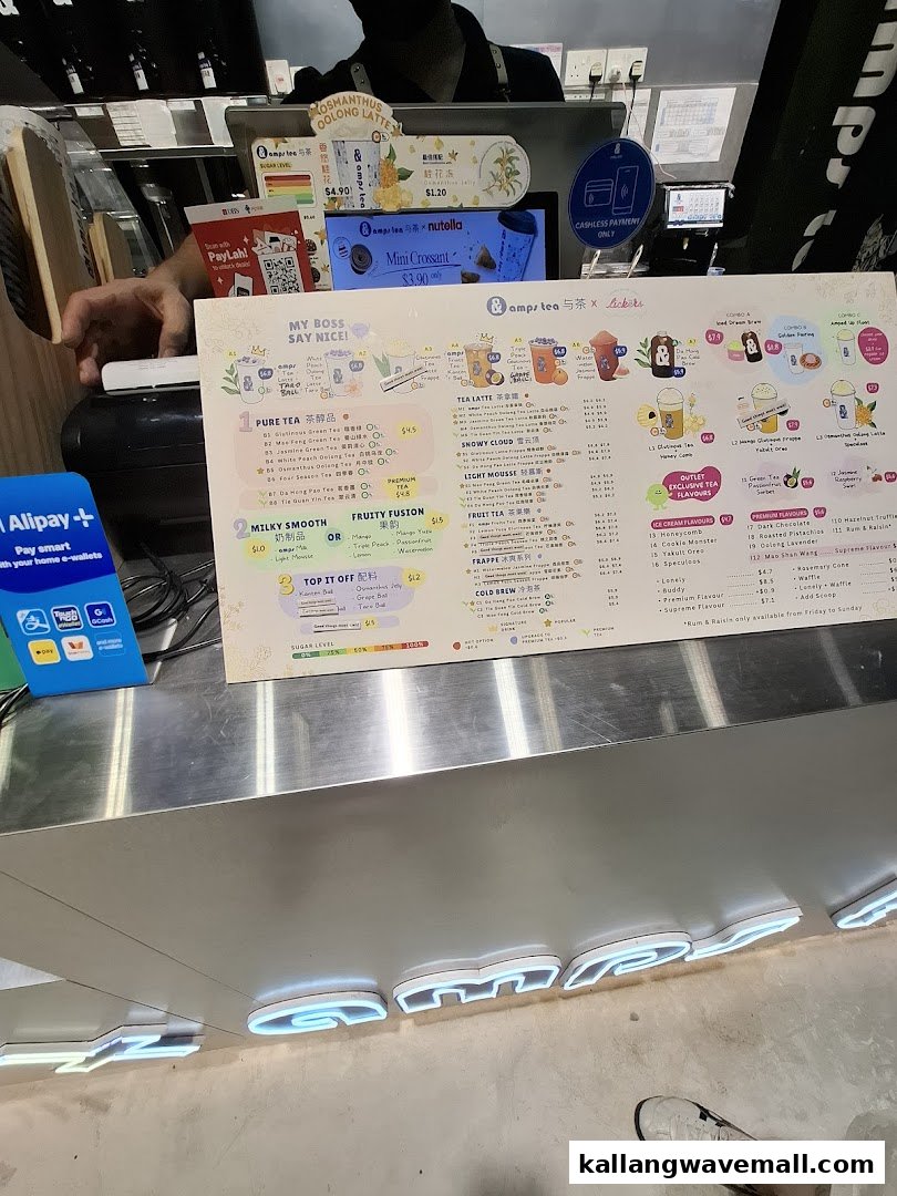 A detailed menu board displaying various tea, smoothie, and ice cream options with prices and payment methods.
