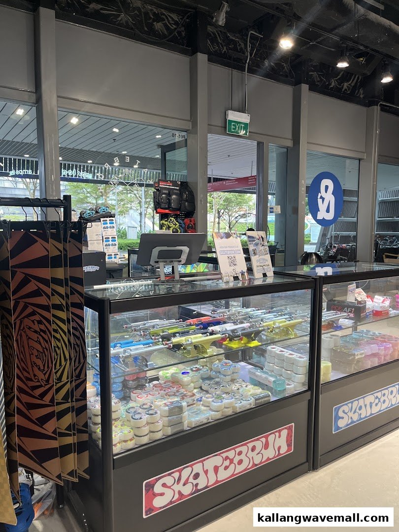 Interior view of a retail space featuring display cases filled with skateboard parts and accessories.