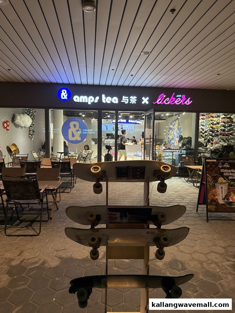 The storefront of amps tea X Lickers, featuring outdoor seating and a skateboard display.