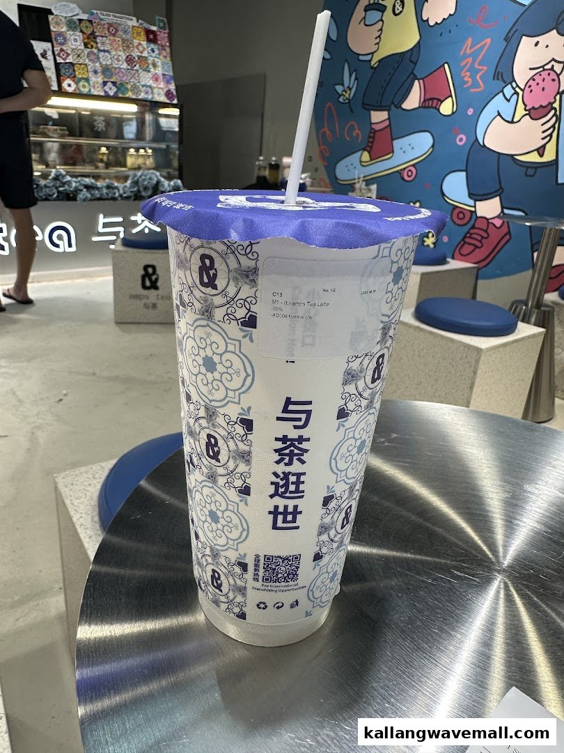 A large, patterned tea latte cup sits on a metallic table inside amps tea X Lickers.