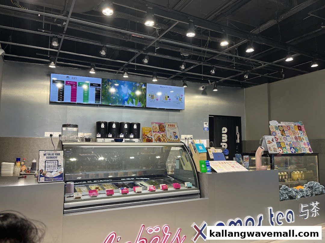 Interior view of amps tea X Lickers, featuring a counter, digital menu screens, and an ice cream display.