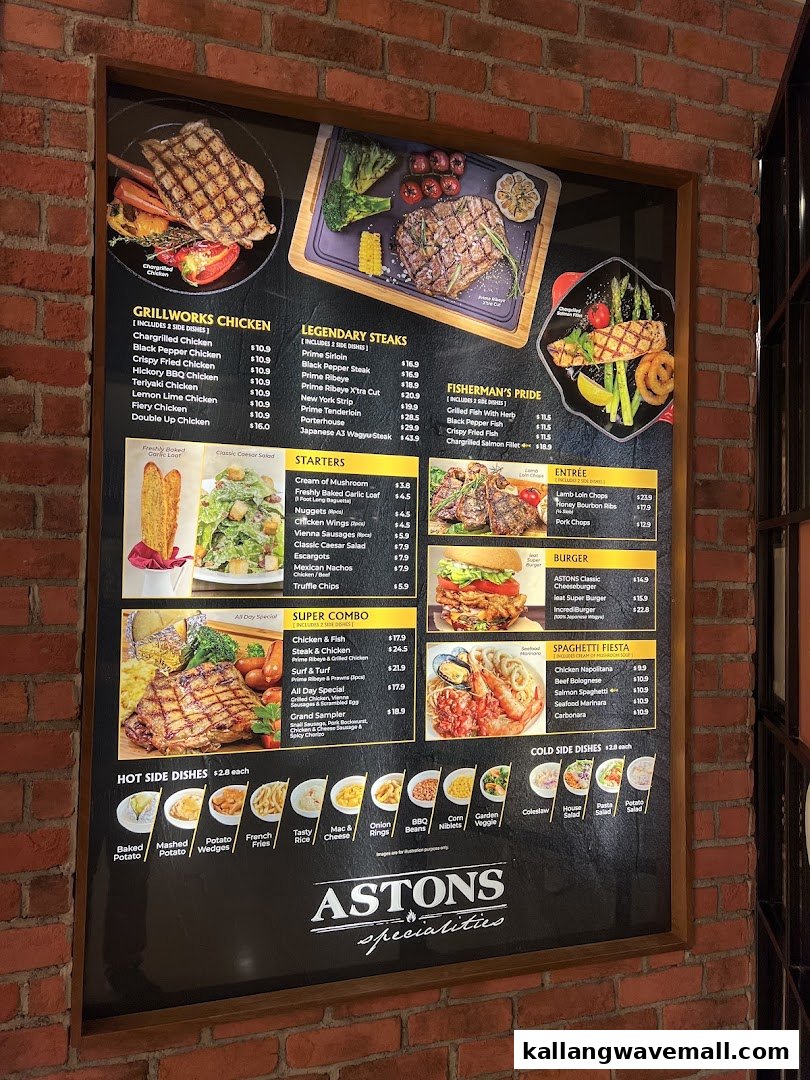A large, illuminated menu board from ASTONS Specialities, showcasing a variety of grilled meats, seafood, and sides.