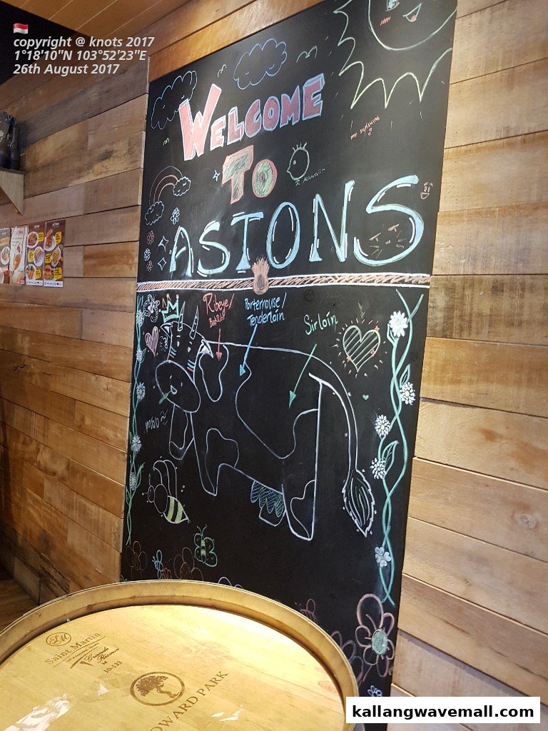 A chalkboard welcome sign for ASTONS Specialities, featuring a diagram of beef cuts.