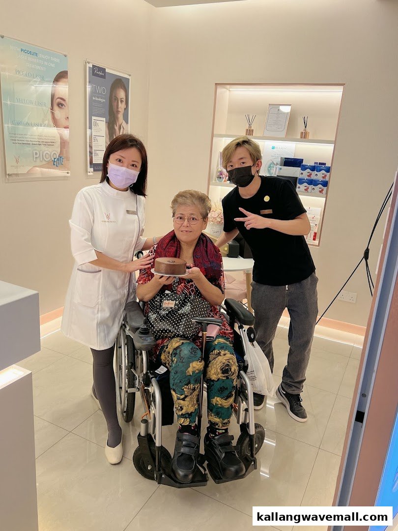 Shop staff celebrating with a customer holding a cake, showcasing a warm, customer-focused environment.