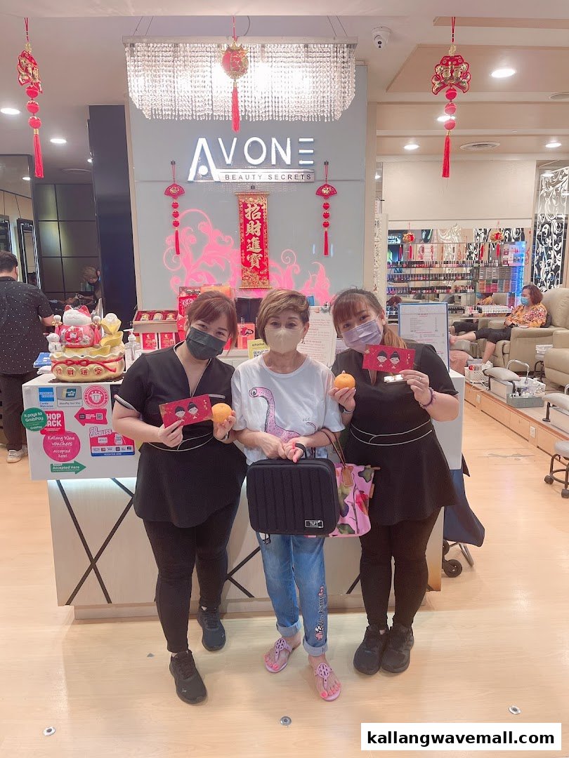 Avone Beauty Secrets staff and a customer celebrating with oranges and red packets inside the salon.