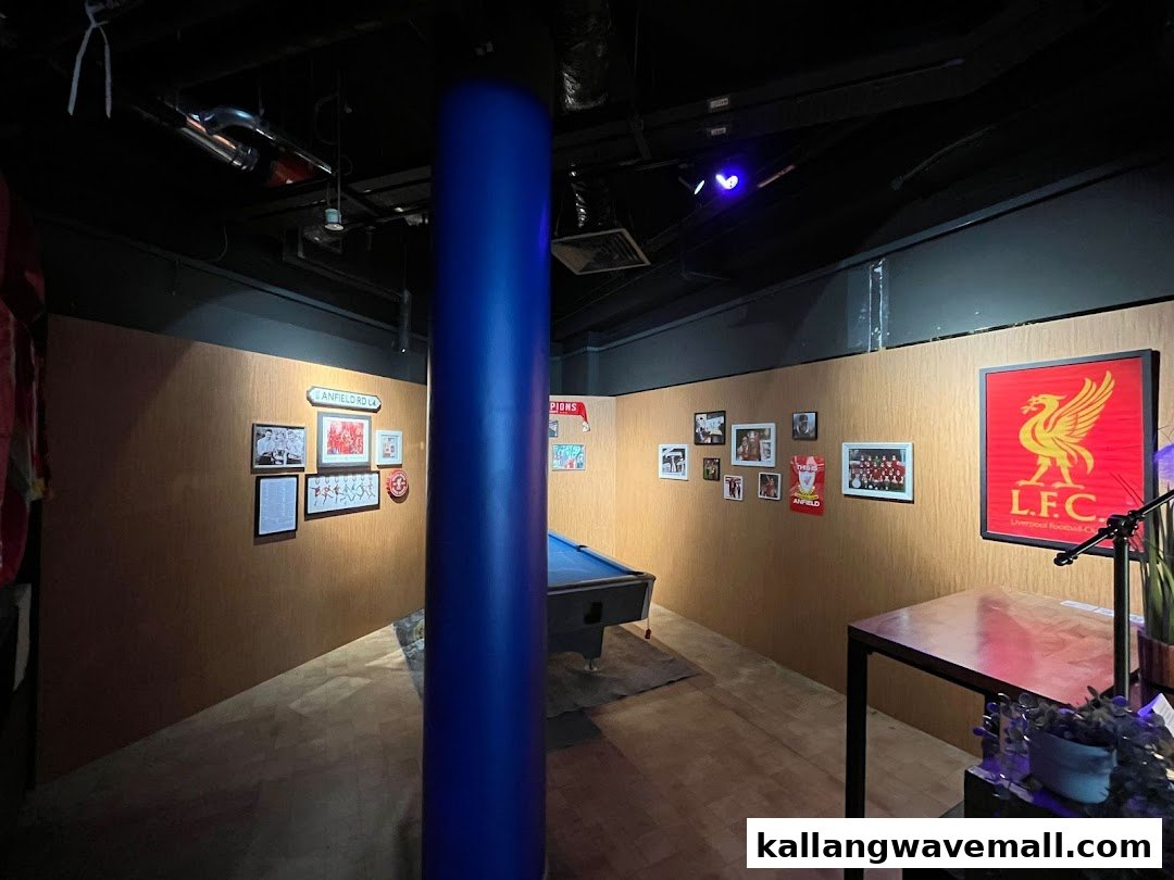 An interior view of Bar Soccer featuring a pool table and Liverpool FC memorabilia.