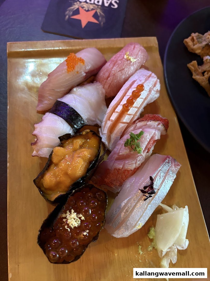 A wooden platter showcases an assortment of beautifully prepared sushi and nigiri pieces.