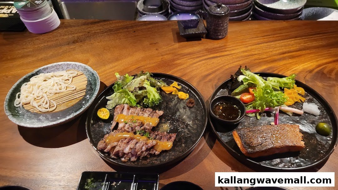 Delicious grilled meats, salmon, and cold noodles served on a wooden table.