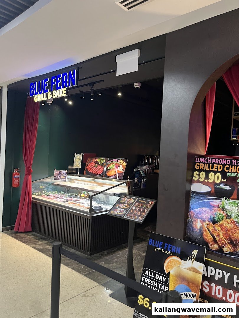 The shopfront of Blue Fern Grill and Sake, featuring a display case and promotional signs.