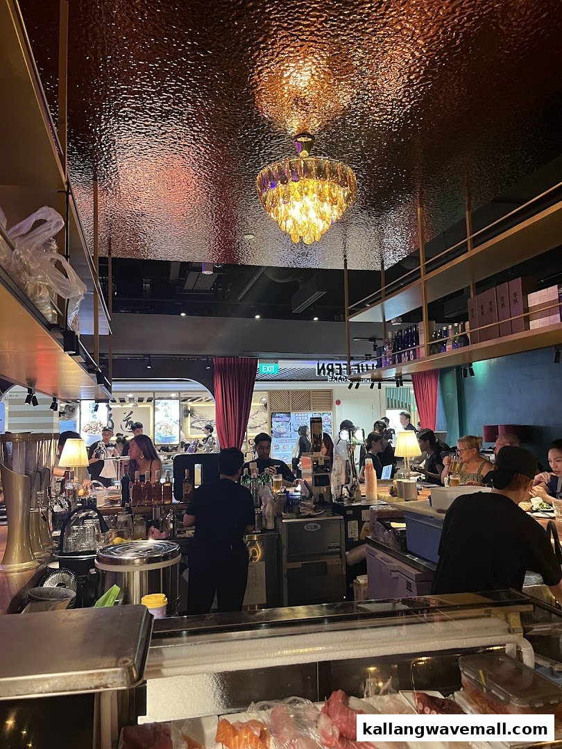 A vibrant interior shot of Blue Fern Grill and Sake, featuring a sushi counter, bar, and diners.