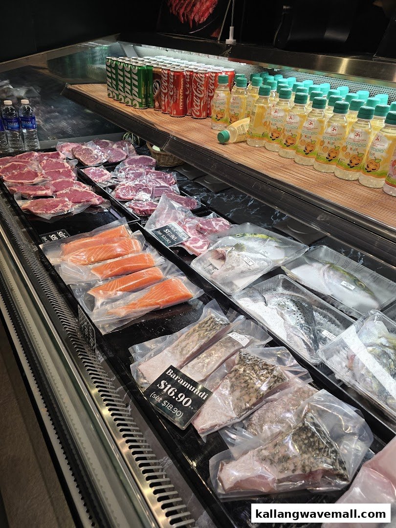 A refrigerated display case featuring fresh cuts of meat, various fish, and bottled beverages.