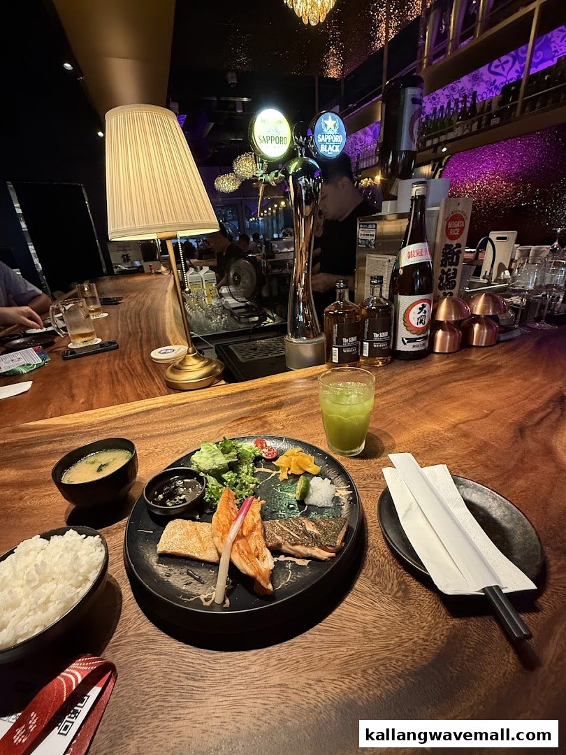 A delicious meal set with fish, rice, and soup on a wooden bar counter at Blue Fern Grill and Sake.