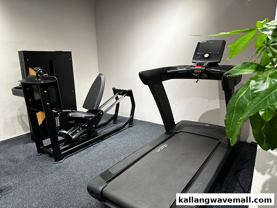 A leg press machine and treadmill in a modern physiotherapy and sports performance clinic.