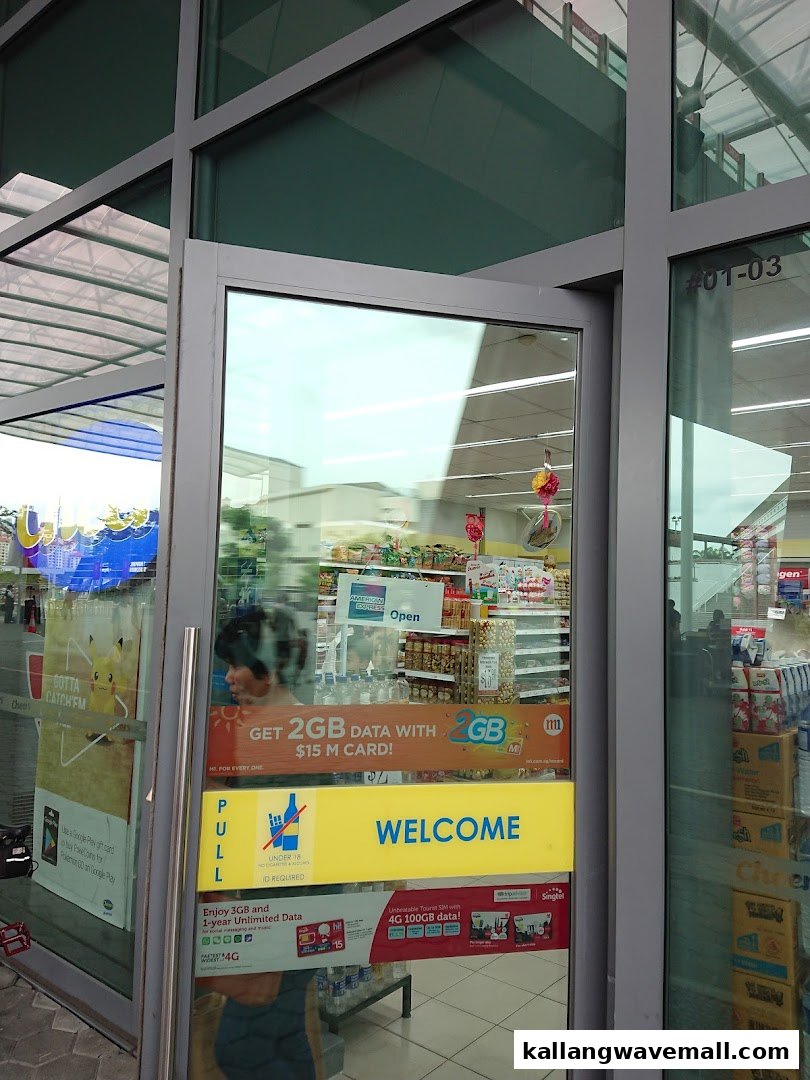 A glass shop entrance with promotional signs and reflections of the interior, inviting customers inside.