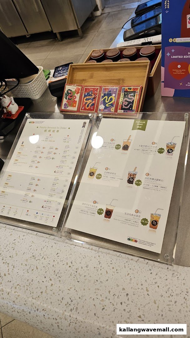 A close-up of the CHICHA San Chen counter displaying their menu boards and some merchandise.