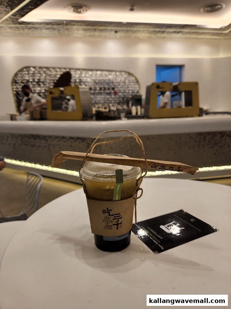 A refreshing drink from CHICHA San Chen on a table, with the modern shop interior in the background.