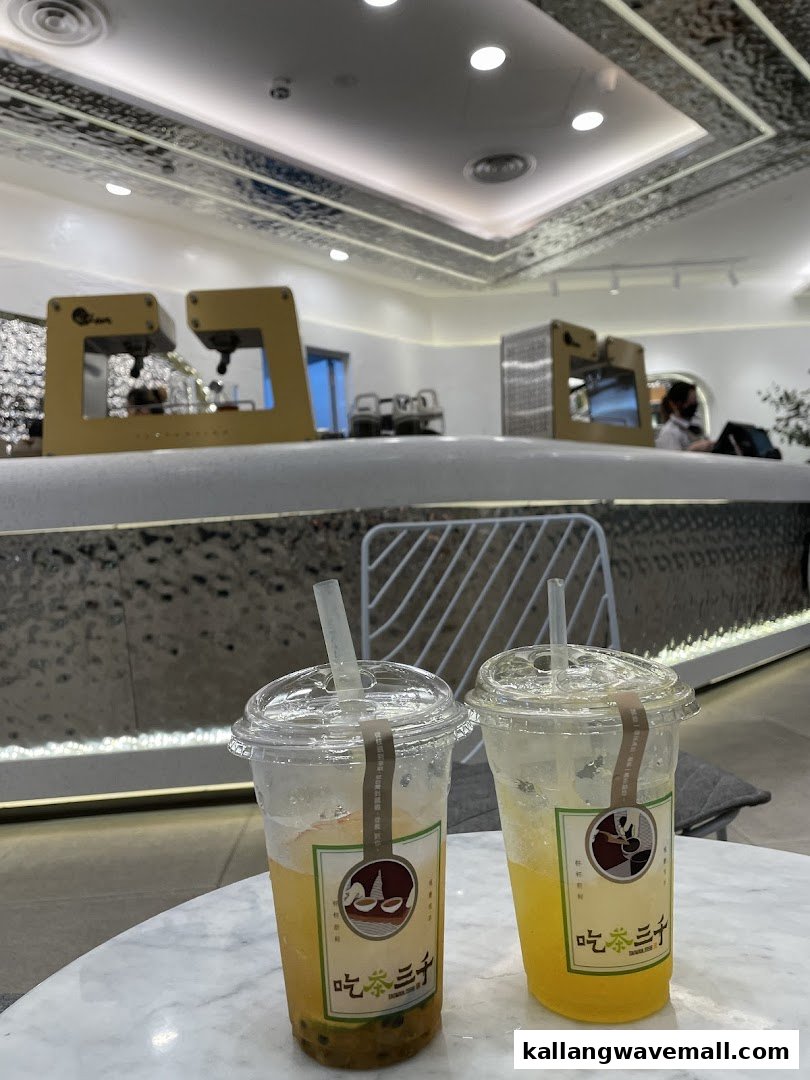 Two refreshing bubble tea drinks on a table inside CHICHA San Chen, showcasing the modern interior.