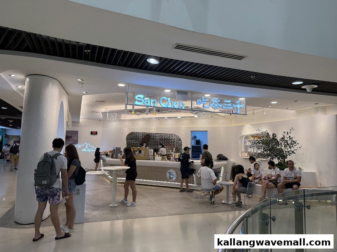 Customers and staff at CHICHA San Chen bubble tea shop, featuring its modern interior and counter.