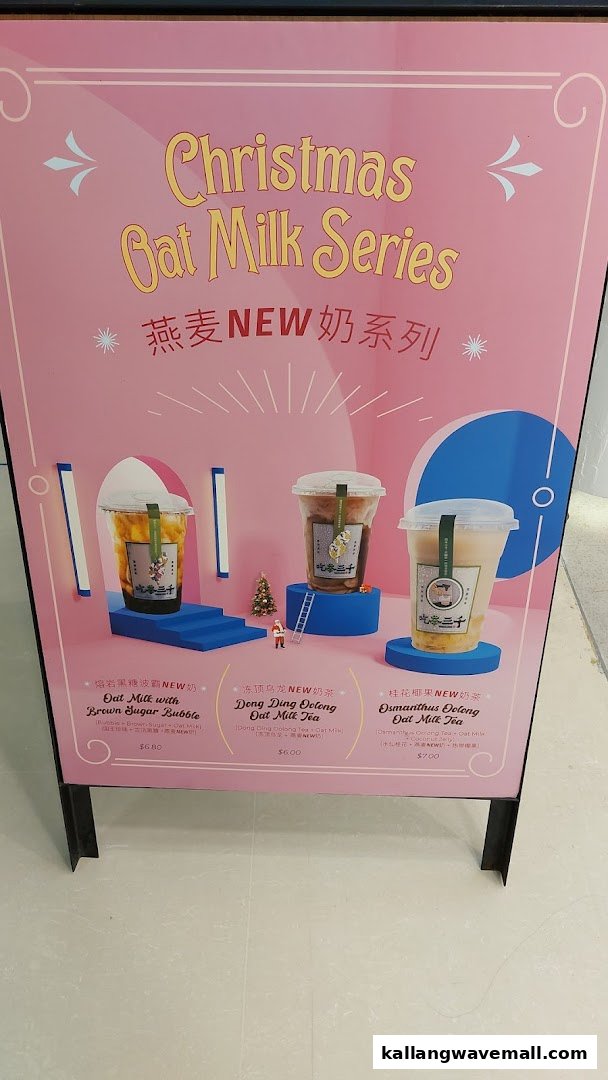 A vibrant pink promotional stand showcasing CHICHA San Chen's new Christmas Oat Milk Series drinks.