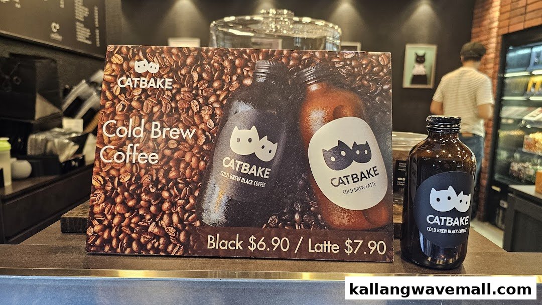 A display board and bottle showcasing CATBAKE's Cold Brew Coffee options and prices.