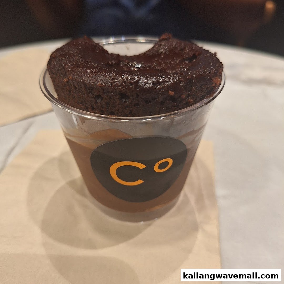 A rich chocolate dessert in a cup with the Chocolate Origin logo.