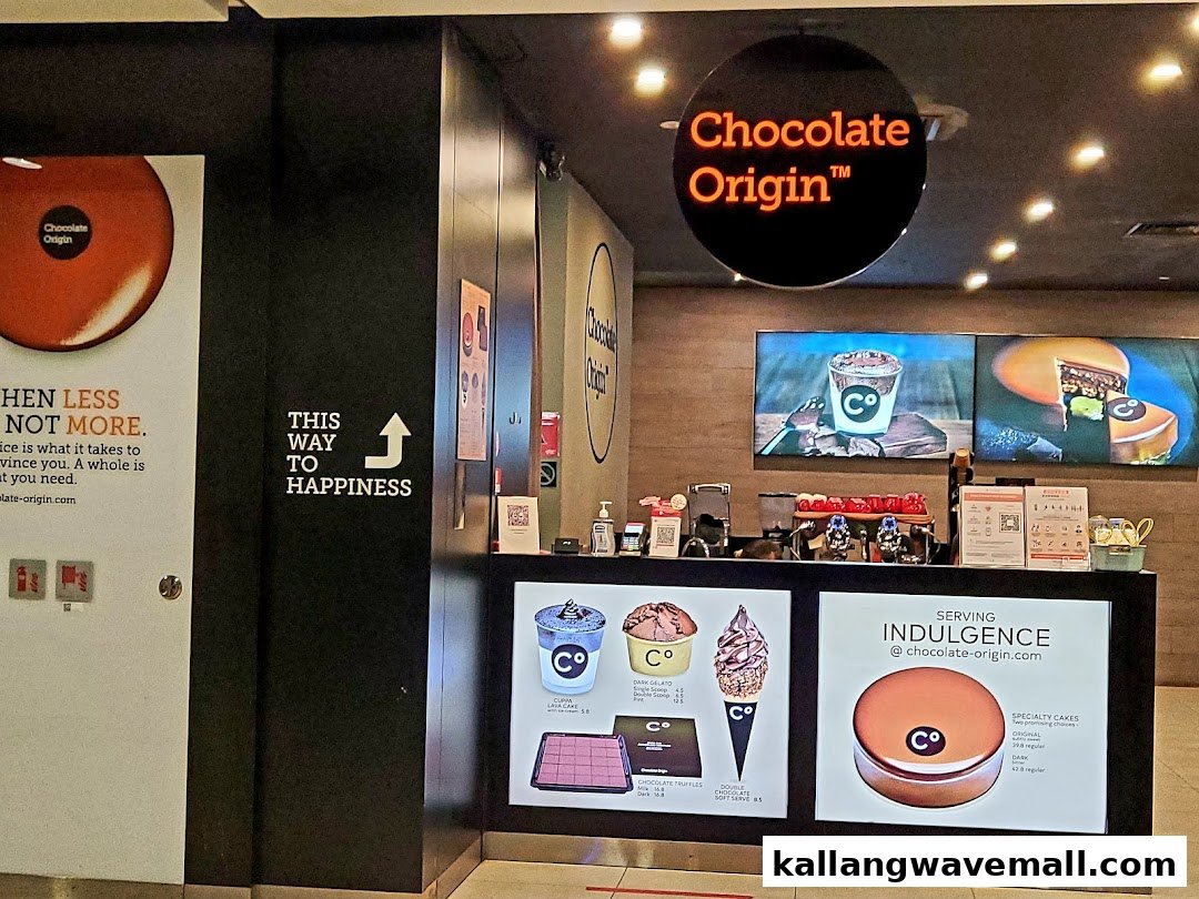 A vibrant interior view of Chocolate Origin's counter showcasing various chocolate desserts and treats.